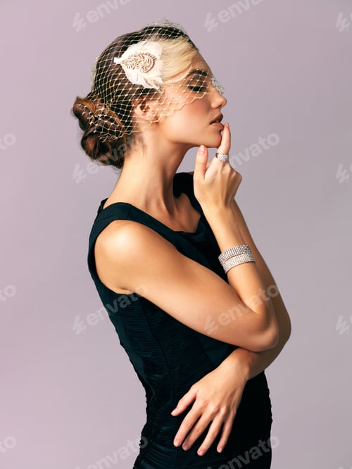 Preview: Studio shot of an elegantly dressed young woman posing against a purple background