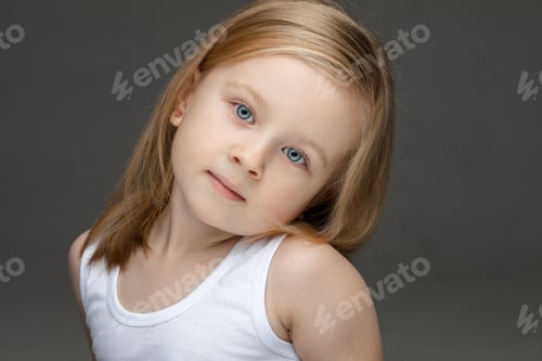 Preview: Portrait of lovely child in photo studio posing alone