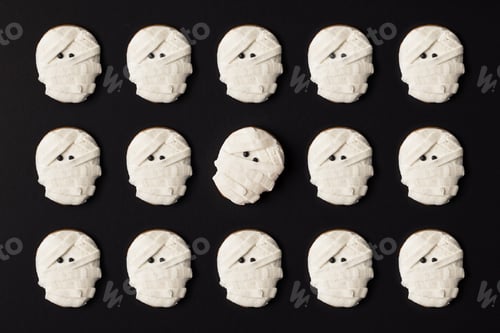 Preview: top view of scary halloween mummy cookies isolated on black