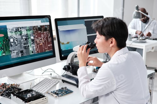 Preview: Young contemporary researcher with microscope