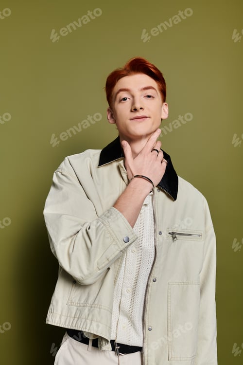 Preview: Young man expressing emotions with confidence against a vibrant green backdrop