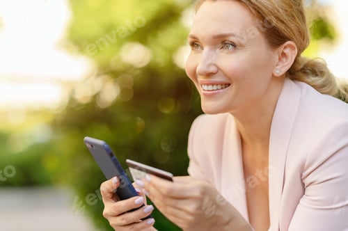 Preview: Smiling Woman Shopping Online with Mobile Device
