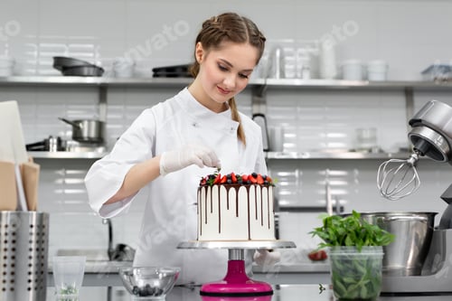 Preview: Pastry chef decorates the cake with chocolate levels of berries and mint
