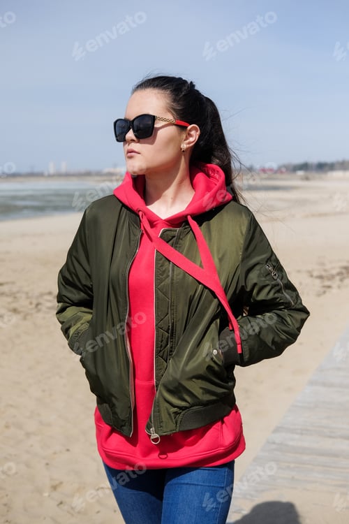 Preview: Woman In A Red Hoodie Walking On The Beach. Close-Up Portrait.