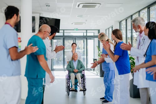 Preview: Medical staff clapping to senior patient who recovered from serious illness.