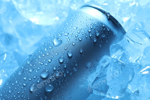 Preview: Refreshing drink in can on ice cubes, closeup. Toned in blue