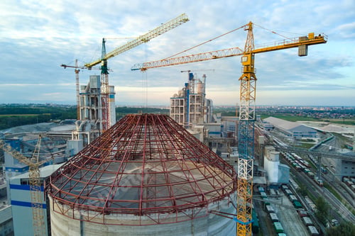 Preview: Aerial view of cement factory under construction with high concrete plant structure