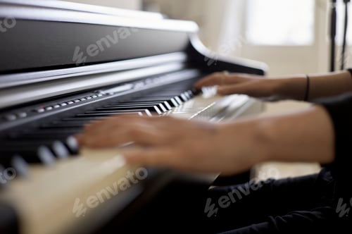 Preview: A person is playing a piano, focusing on their hands moving across the black and white keys.