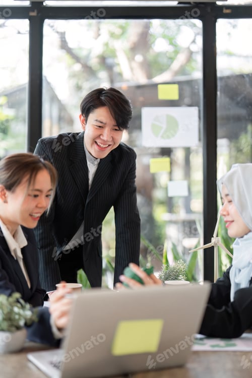 Preview: A team discussing innovative green strategies in a modern workspace.