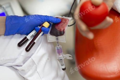 Preview: Selective focus shot of blood donator donating blood in the hospital