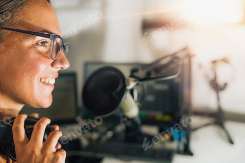 Preview: Young Woman Hosting a Talk Show from Her Studio, Wearing Headphones, Talking to the Microphone