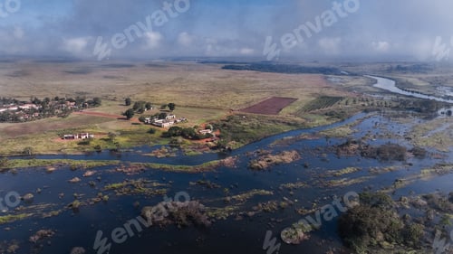 Preview: Aerial view of farmlands in Angola with waterlogged fields and lush greenery