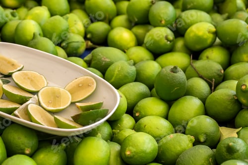 Preview: Green fresh lemon lime texture background / pile of lime lemon for sale in the market