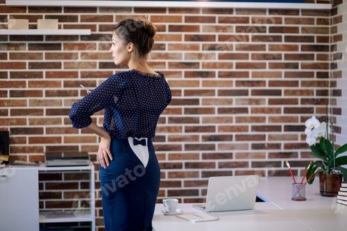 Preview: Attractive woman thinking in office