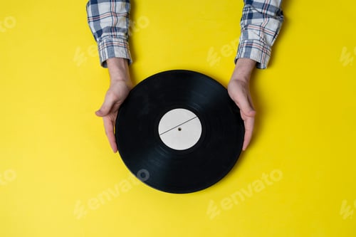 Preview: a top view of music lover holding vinyl music record