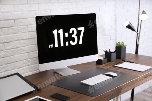 Preview: Modern workplace interior with computer and devices on table near brick wall