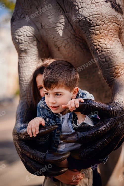 Preview: Boy Held in Dinosaur Claws at Outdoor Exhibit