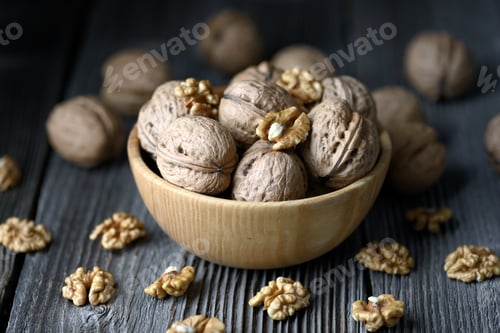 Preview: Walnut nuts and kernels on wooden table close up