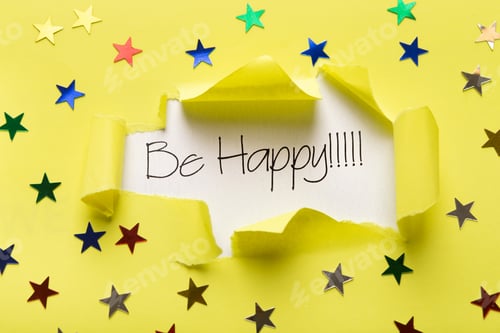 Preview: Be happy phrase showing up under torn yellow paper