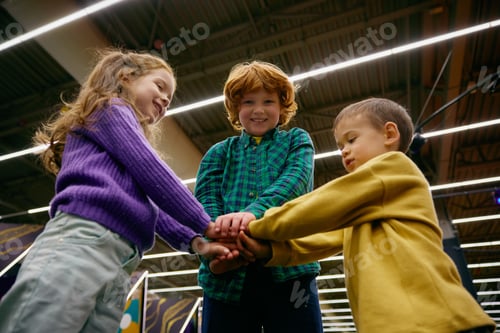 Preview: Children having fun in play area standing in circle