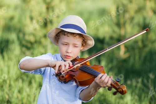 Preview: Boy playing violin outside classroom, child boy is playing the violin standing in park background