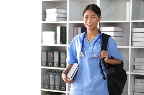 Preview: Internship medical students carry bags and textbooks in the library.