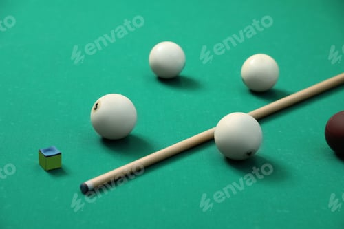 Preview: Billiard balls, cue and chalk on table