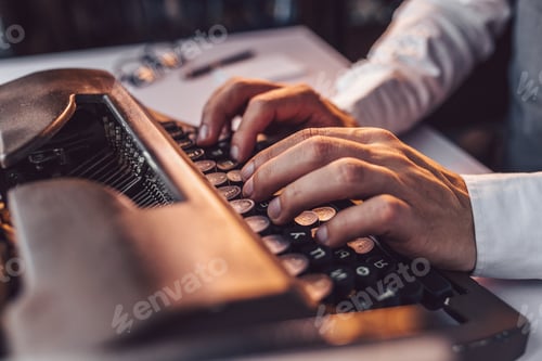 Preview: Male hands typing on a retro typewriter