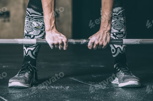 Preview: woman legs and hands holding and lifting a bar weights training working out in Gym
