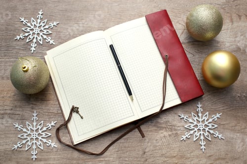 Preview: Notebook on wooden table. New year's decoration and christmas balls. Copy space for notes.