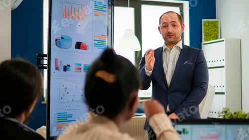 Preview: Professional man entrepreneur planning new project with his coworkers