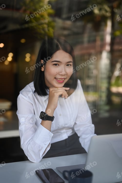 Preview: Professional Young Woman Working at Urban Cafe