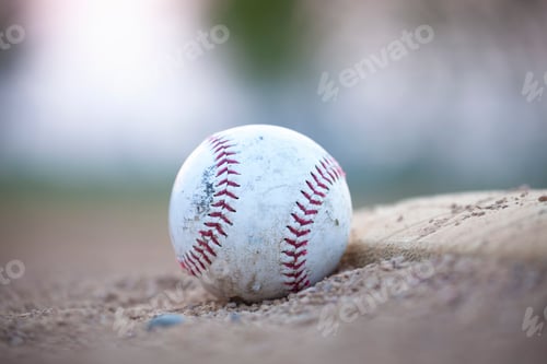 Preview: Selective focus low angle view of an old baseball next to a base