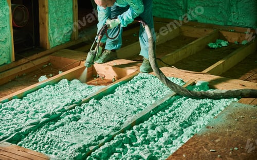 Preview: Worker spraying polyurethane foam for insulating wooden frame house.