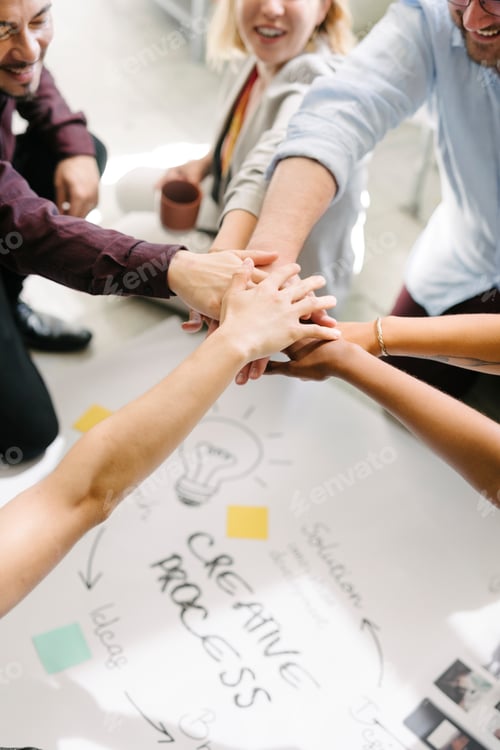 Preview: Diverse startup business team stacking hands