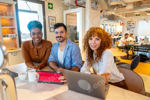 Preview: Diverse business people collaborating in modern coworking office