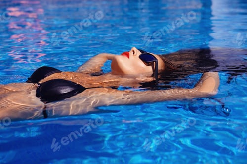 Preview: Beautiful girl in outdoor pool
