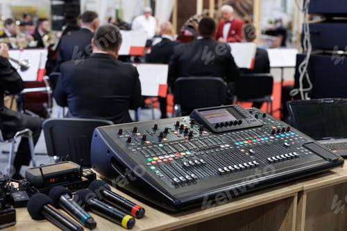Preview: Professional concert mixing console and microphones at the conference.