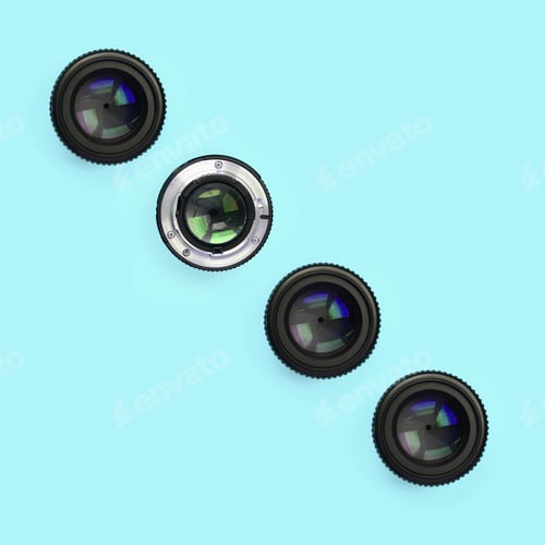 Preview: A few camera lenses with a closed aperture lie on texture background of fashion pastel blue