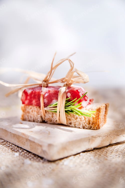 Preview: Elegant Salami Appetizer Topped with Rosemary and Bow