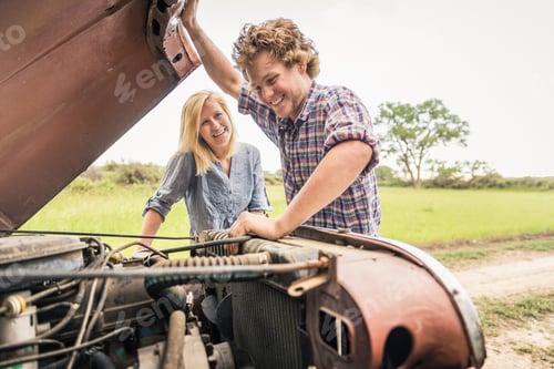 Preview: Young man and girlfriend checking jeep engine