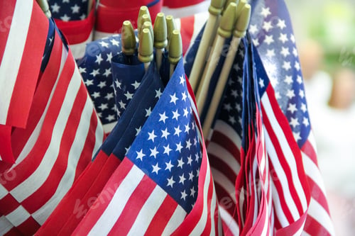 Preview: Closeup view of many United States flags ready for July 4 Independence Day patriotic celebration.