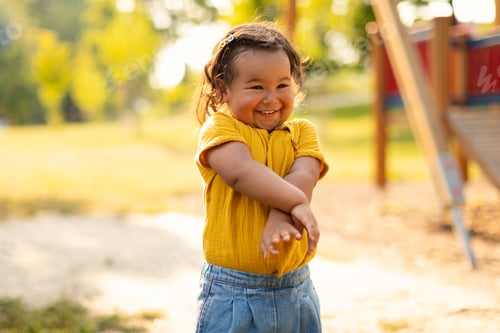 Preview: Adorable Asian Baby Girl Smiling And Having Fun Standing Outdoor