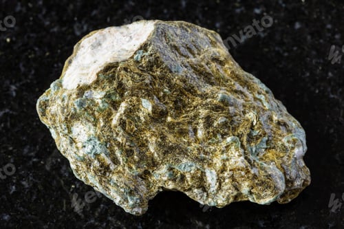 Vista previa: sample of raw lobanovite rock on black granite