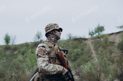 Preview: Portrait of Ukrainian soldier wearing mask and patroling at the range