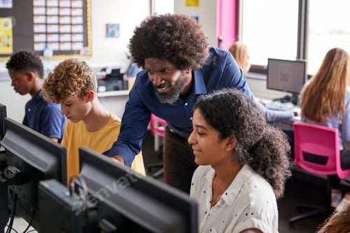 Preview: Male Teacher Helping Teenage Female High School Student Working In Computer Class