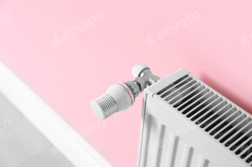 Preview: Heating radiator with thermostat near color wall