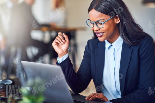Preview: Smiling young African American businesswoman working online in her office