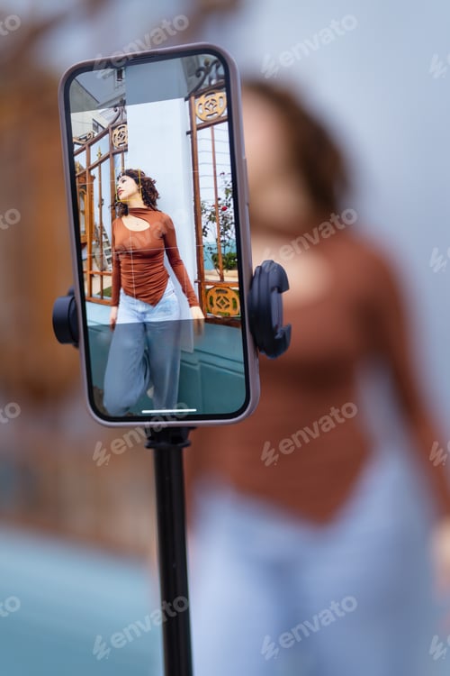 Preview: Influencer posing for fashion photoshoot using smartphone gimbal