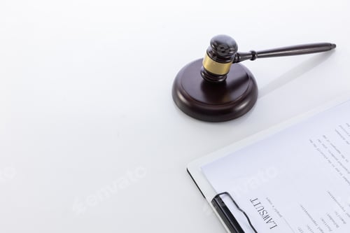 Preview: Closeup shot of the judge's gavel on a document of the lawsuit